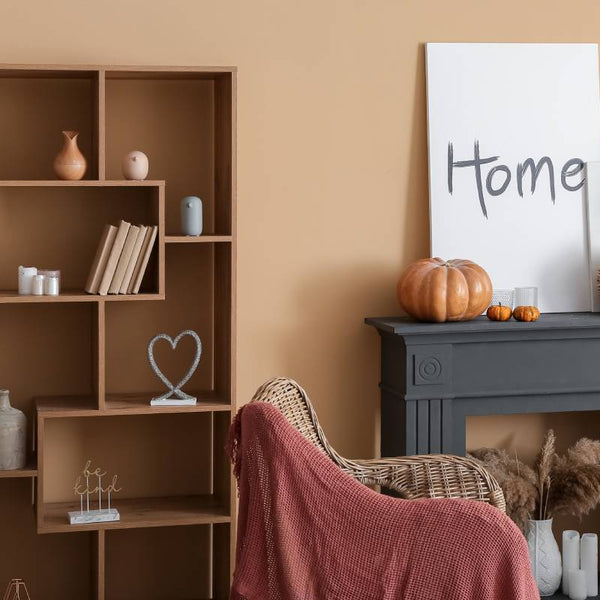 Warm, neutral paint colors in a cozy, Autumnal living room with a matte black mantle at Hoover Paint near Nashville, TN